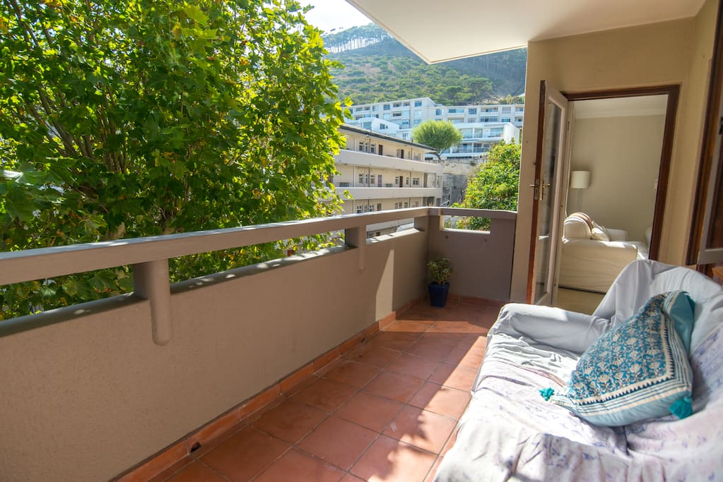Our large, sunny balcony has two comfortable couches (perfect for afternoon naps), a big tree outside and nice views of Signal Hill (with a tiny bit of sea view on the other side of the balcony).