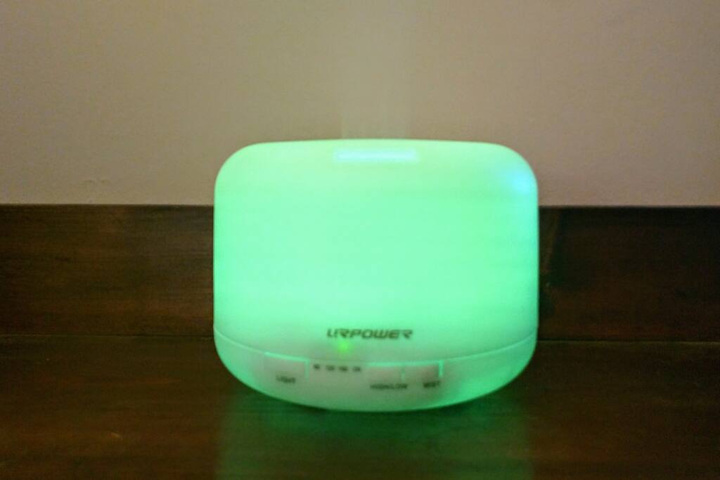 Room equipped with essential oil diffuser & lavender and other essential oils to promote a serene atmosphere.