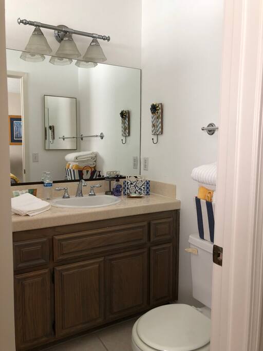 Adjoining bathroom. Has shower and bath tub.