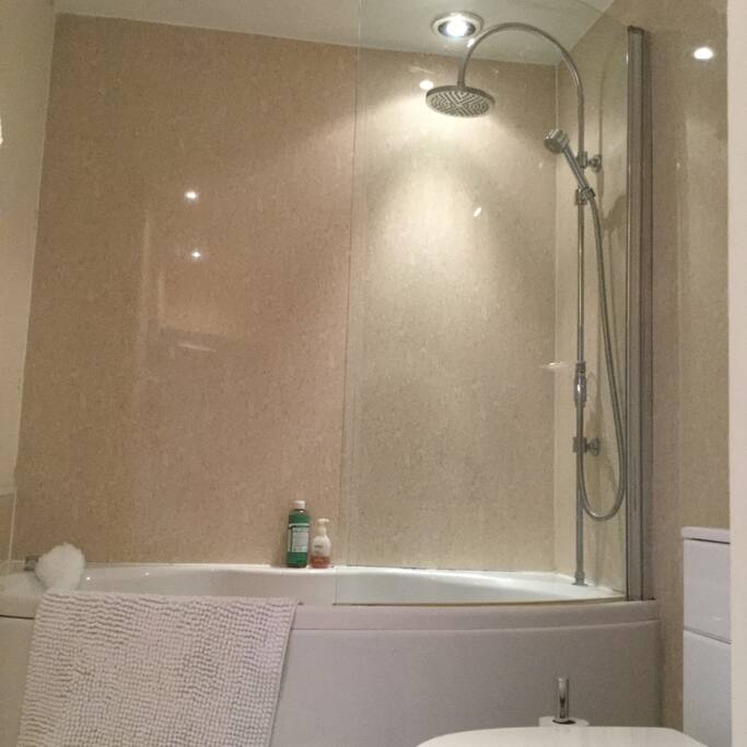 Shared bathroom with bath and shower