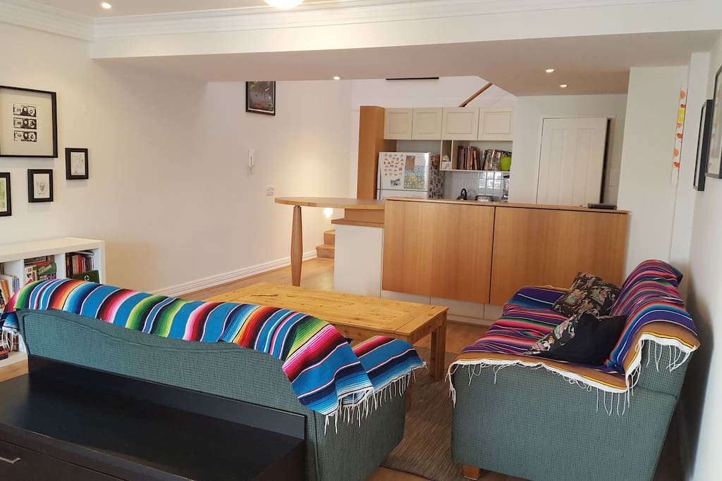 Open plan living room and kitchen on lower level.