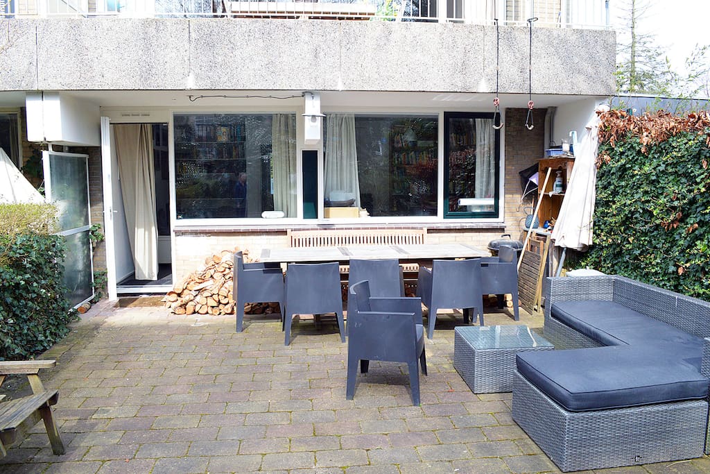 The sunny garden with big table and corner to relax in
