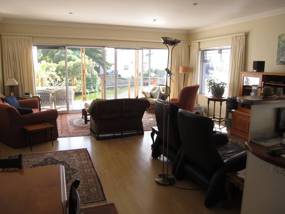 Dining room table and lounge area on to deck with sliding doors