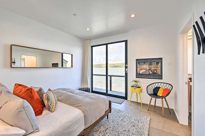 Master Bedroom on the Bay - Spectacular unobstructed bay views, large Fleetwood Sliding Door to over-water deck, in-wall gas fire, books, side table and thoughtful simplistic modern decor.