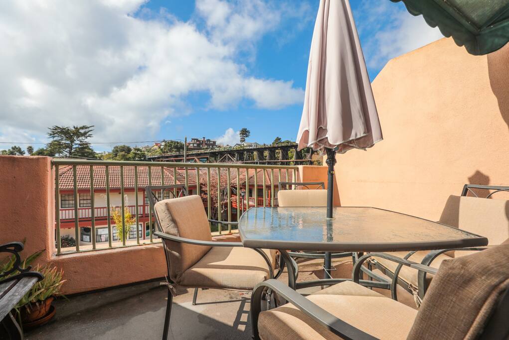 Condo balcony patio with seating for four.
