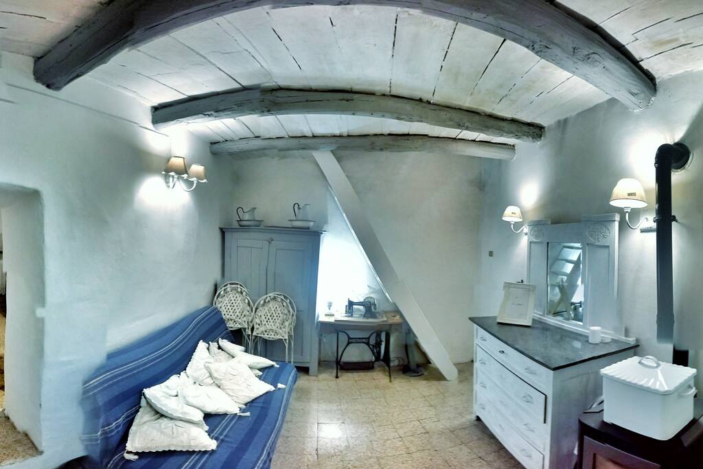 The living room, and the stairs to the bedroom
