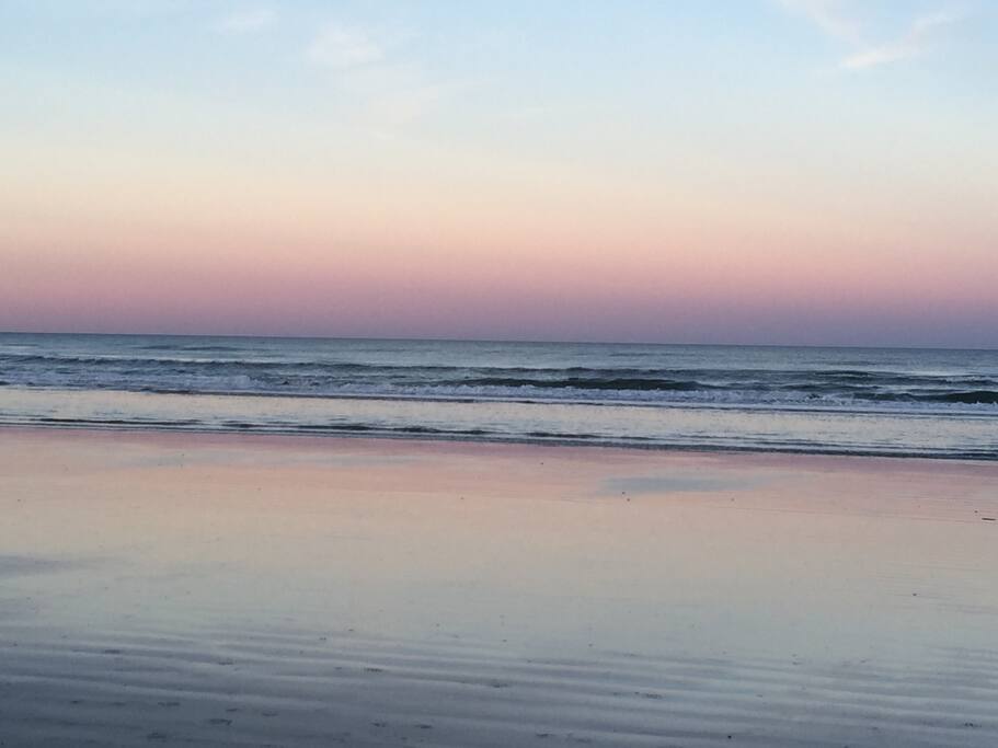 View of the beach from the balcony at sunset.