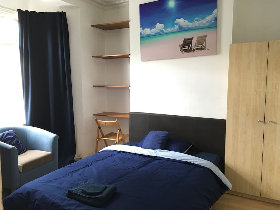 Ground floor bedroom: double bed, wardrobe, armchair, sitting area and chair