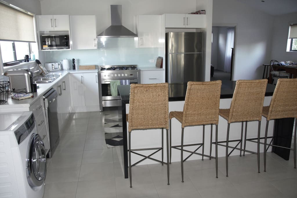 Full kitchen: 900mm oven with gas cooktop, full size fridge, dishwasher, washing machine/dryer/steamer, pod coffee machine, royal doulton crokery, scanpan cookware, convection/grill microwave oven, outdoor glassware for use on the deck