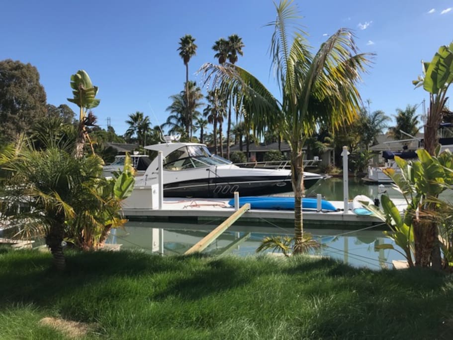 Backyard dock can accommodate 60' yacht. includes kayak and paddle boards for water play.