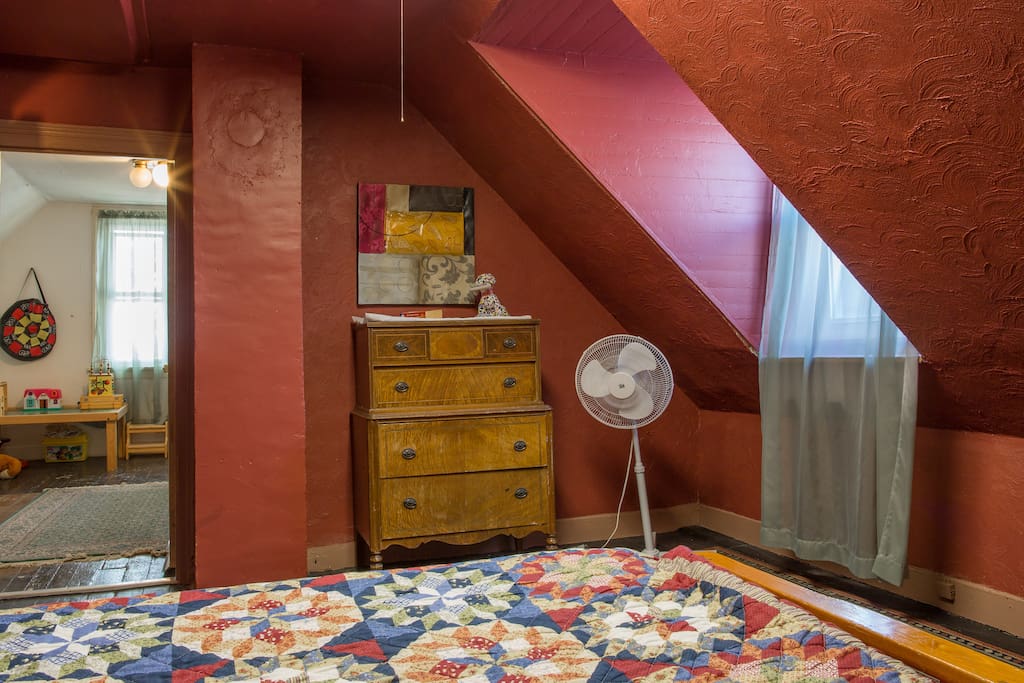 The double bed and one of the two dressers for guests in the large upstairs bedroom, Air conditioner unit in place, and plenty warm in winter!