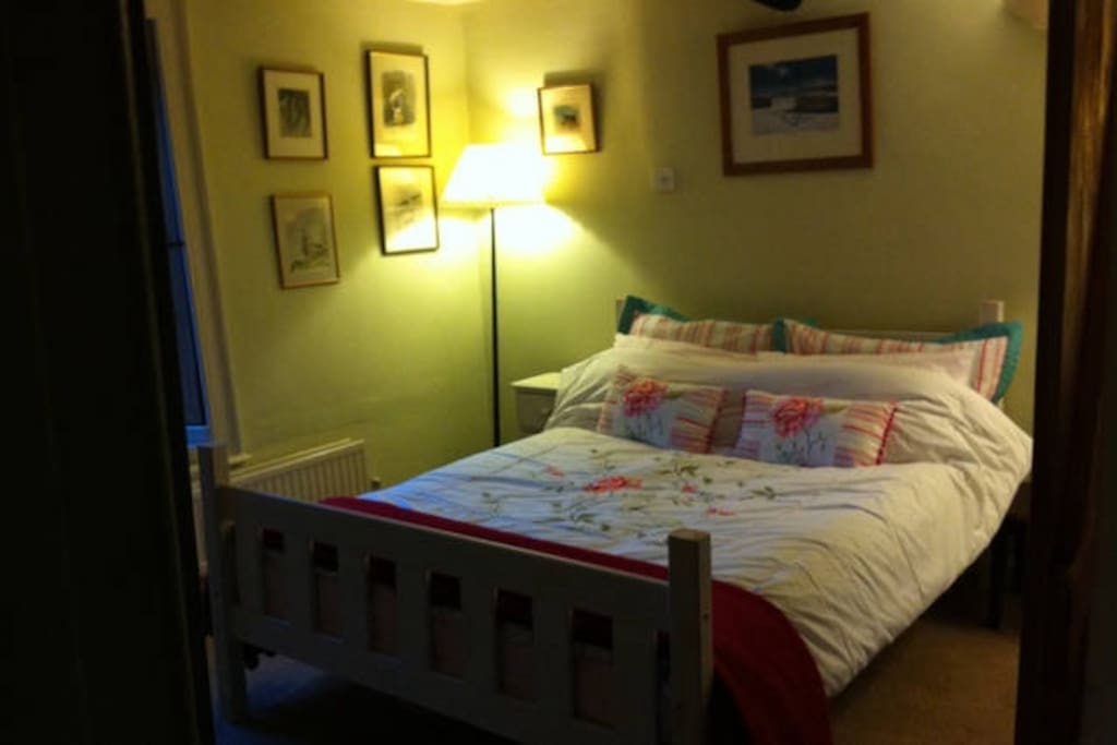 Comfy double bed in downstairs room off the kitchen.