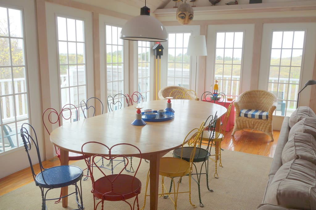 Dining area with deck in background and view to conservation land and harbor