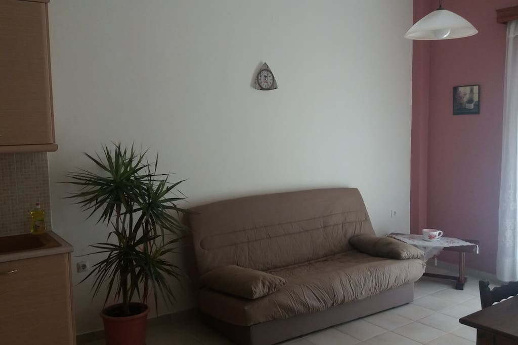 open plan living room - kitchen(with double sofa bed, table and chairs)