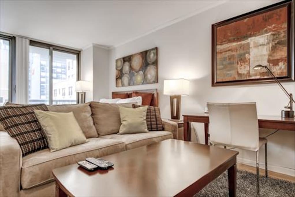 Living Room area features a work desk with chair, flat panel LCD TV with cable channels, DVD player and stereo CD system.