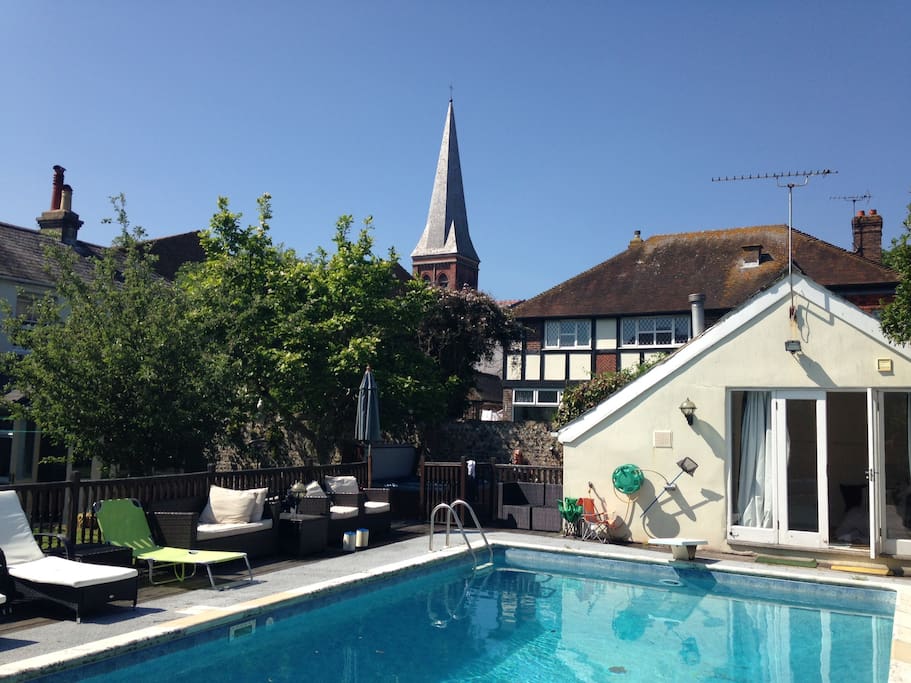 Pool, diving board and a view of the beautiful church spire