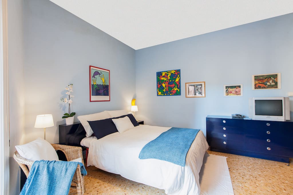 bedroom with king size bed, wardrobe, dressing table, small armchair, bedside tables, night lights