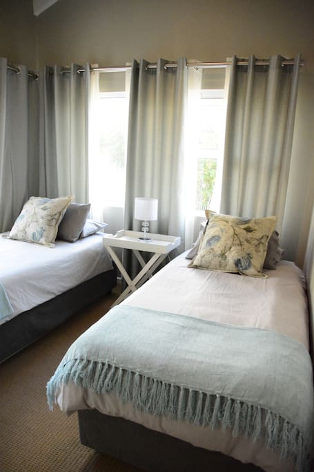 The 2nd bedroom has two comfortable hotel quality single beds with plenty cupboard space.