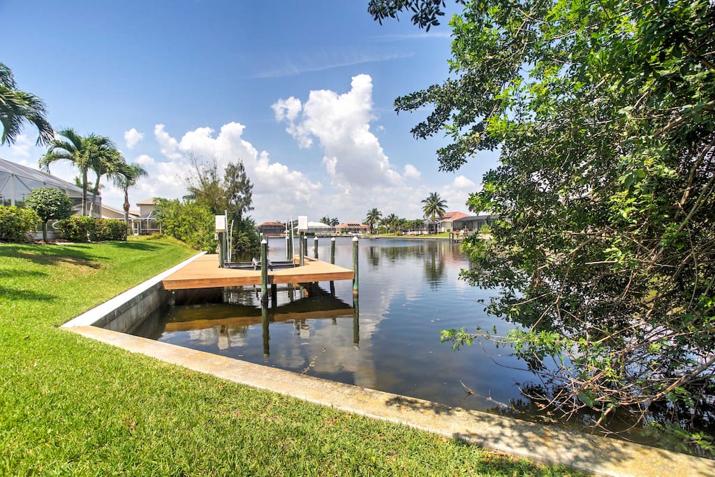 This beautiful home is situated on an over-sized corner lot on the Capri Canal.