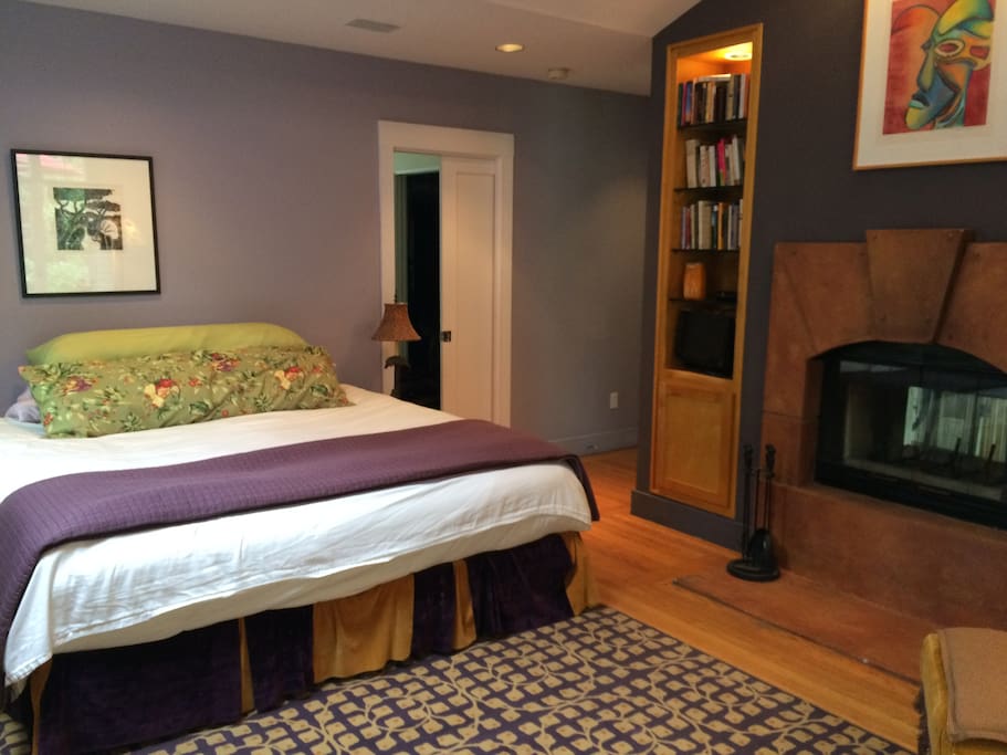 Fireplace, king bed and path to the closet/dressing area and bathroom.