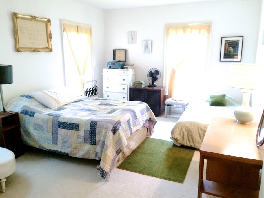 The full-size bed with comfortable room amenities.