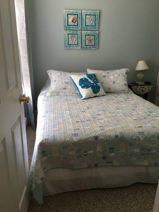 Queen size bed with new bedding and fresh new carpeting