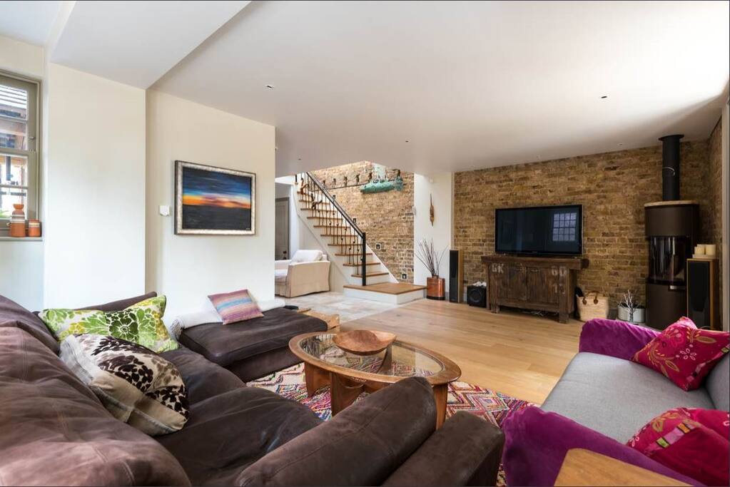 Our living room adjacent to the entrance hall and stairs leading to your bedroom