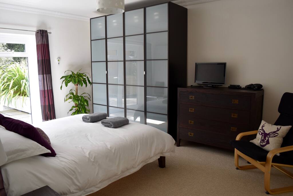 Main bedroom with European Kingsize bed (160cm wide), two large wardrobes with drawers and french windows leading out on to the outdoor terrace area. Plenty of room for a travel cot (supplied) if required.