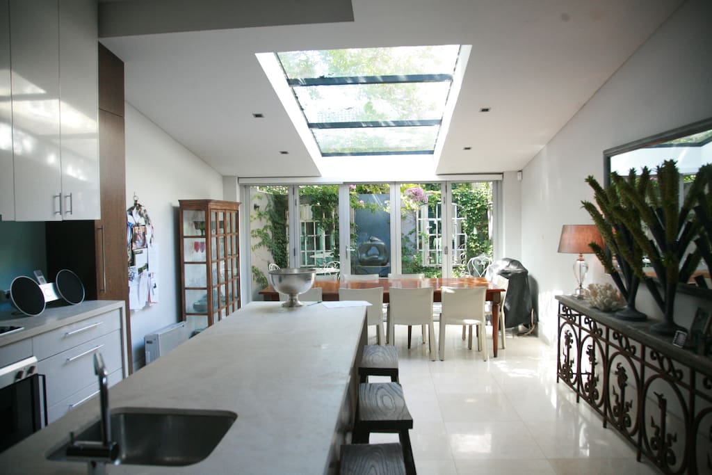 Massive kitchen and dining area that spills out onto a private leafy courtyard.