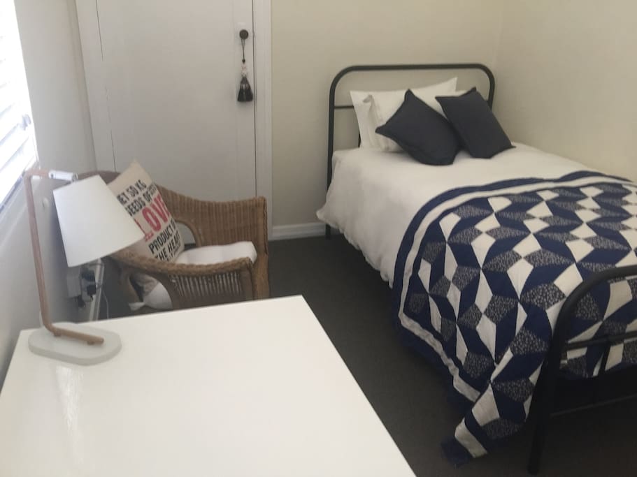 Third bedroom with king single bed, desk and storage.