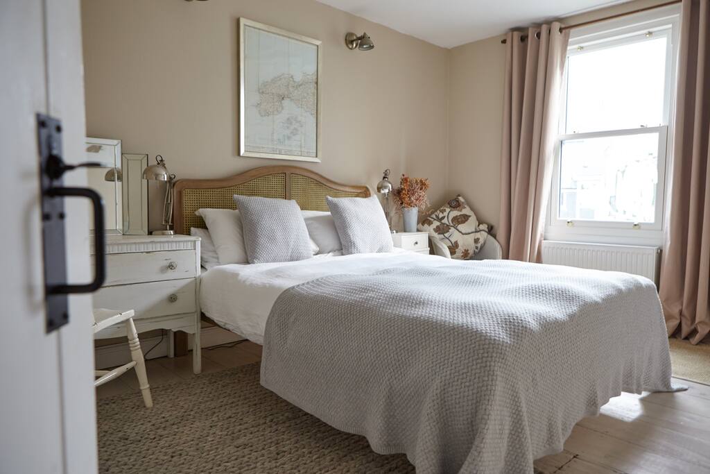 Wooden rattan King sized bed with luxury mattress and cotton bedding