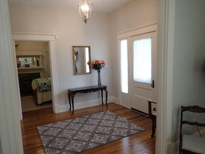 The spacious foyer offers a lovely transition from the living room to the front bedroom.