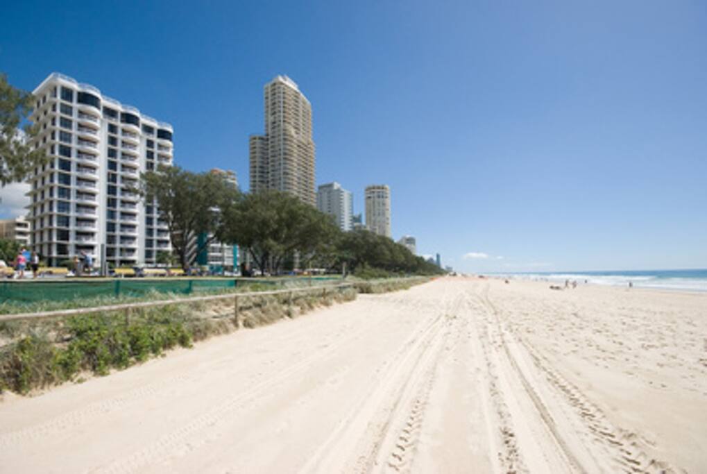 Photo of the building and the beautiful beach, across the road and your there.
