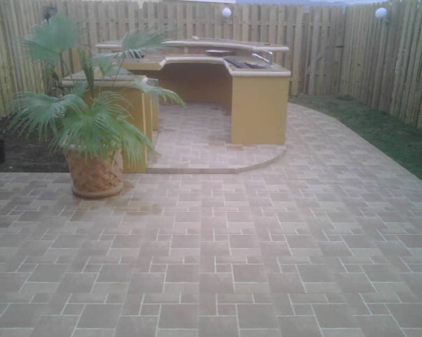 Backyard out door kitchen area with surrounding lights for entertainment