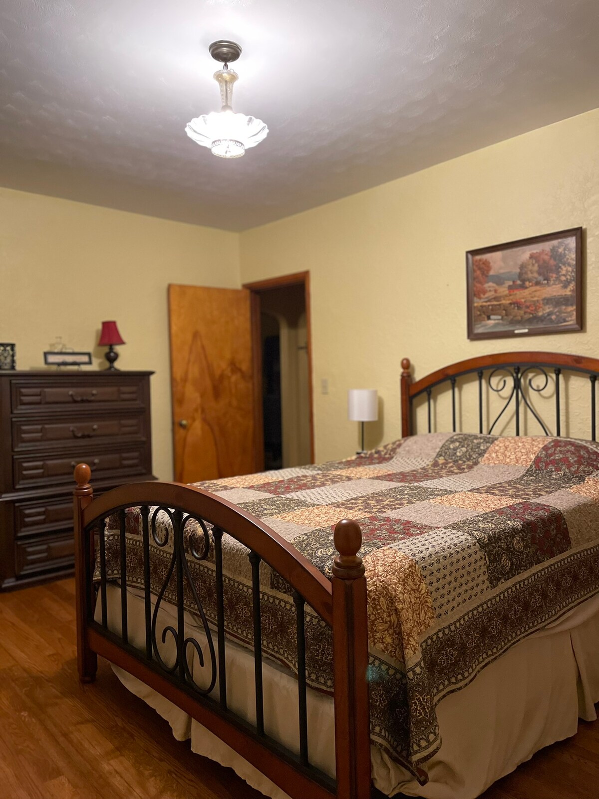 2nd bedroom on the main floor with a queen bed.  AC window unit for summer. Both lamps beside the bed & alarm clock have USB charging ports.
The bathroom is across from this bedroom.