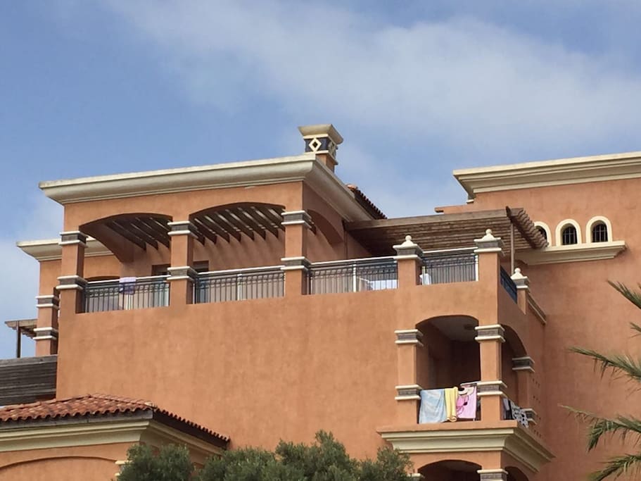 Top Floor Balcony equiped with barbeque area and outdoor patio furniture