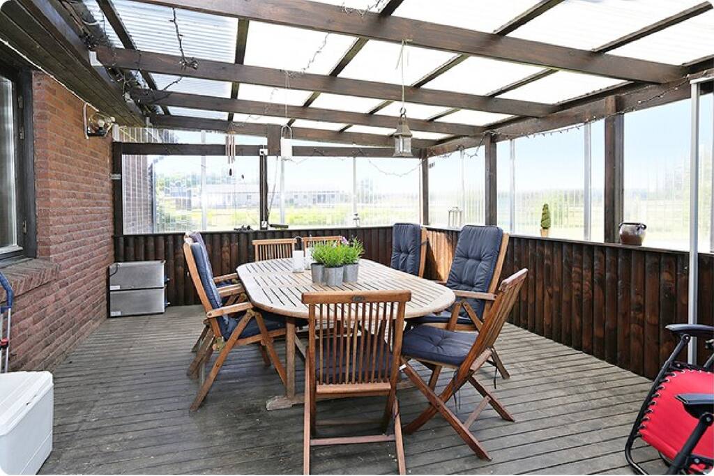 Glassed in porch with plenty of room for the family for cozy summer nights