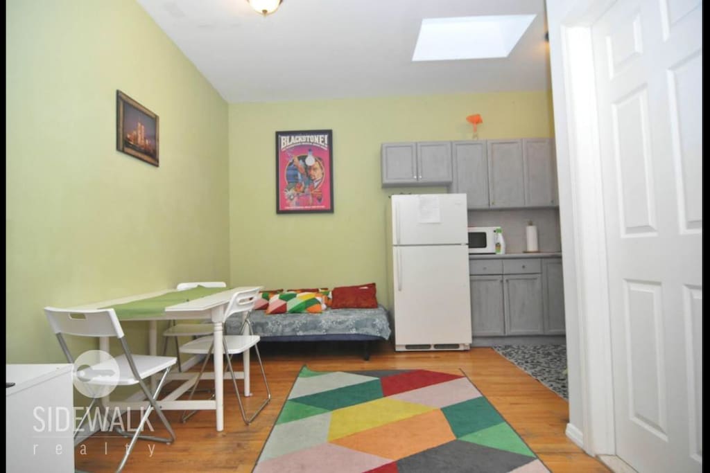 Living area with futon bed and tv and apply box and wifi and centralized A/C