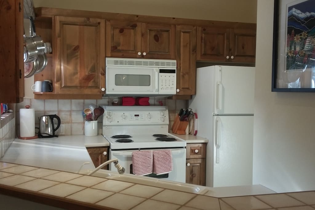 Fully stocked kitchen with a variety of pots & pans, utensils and bakeware