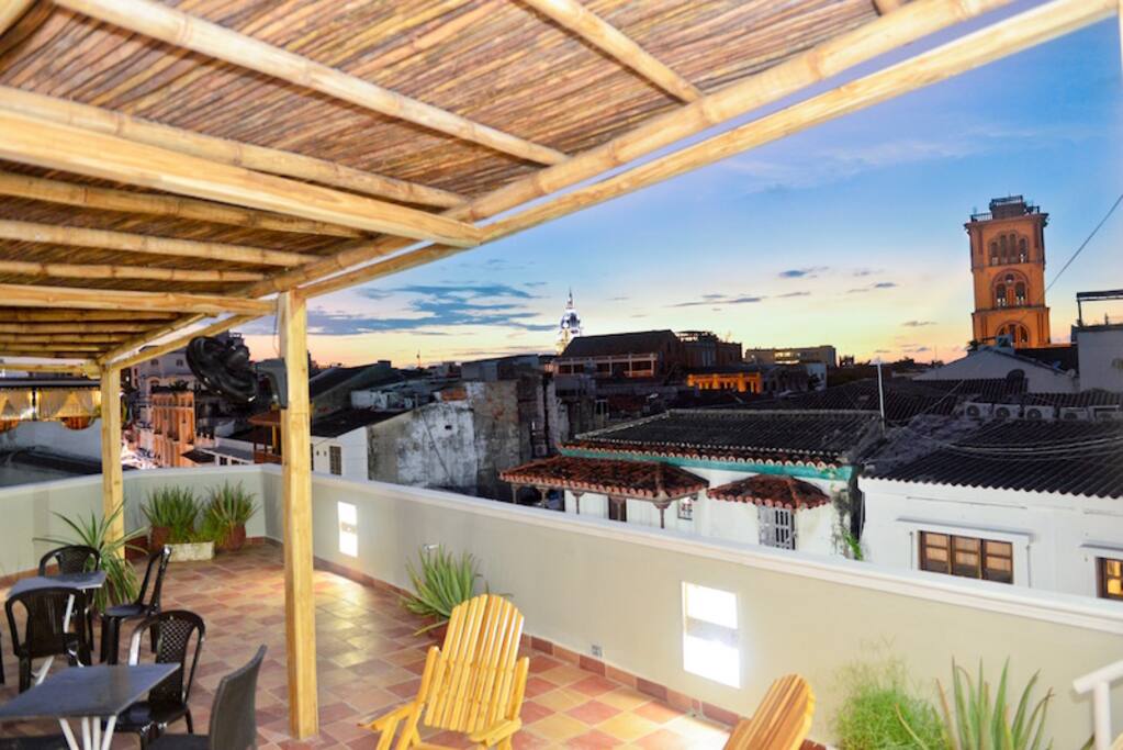 Amazing roof deck with bamboo shade cover & fans -- makes it great during the day or evening!