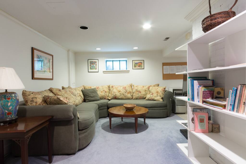 Living room with Smart TV adjacent to kitchenette