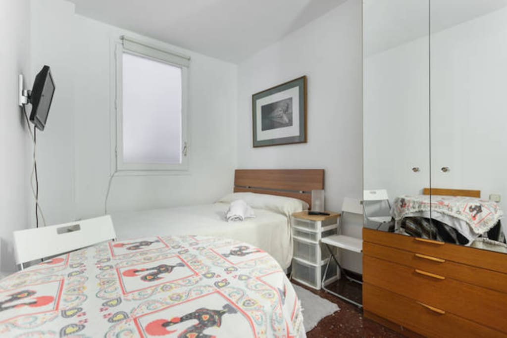 queen bed bedroom with closet and small table