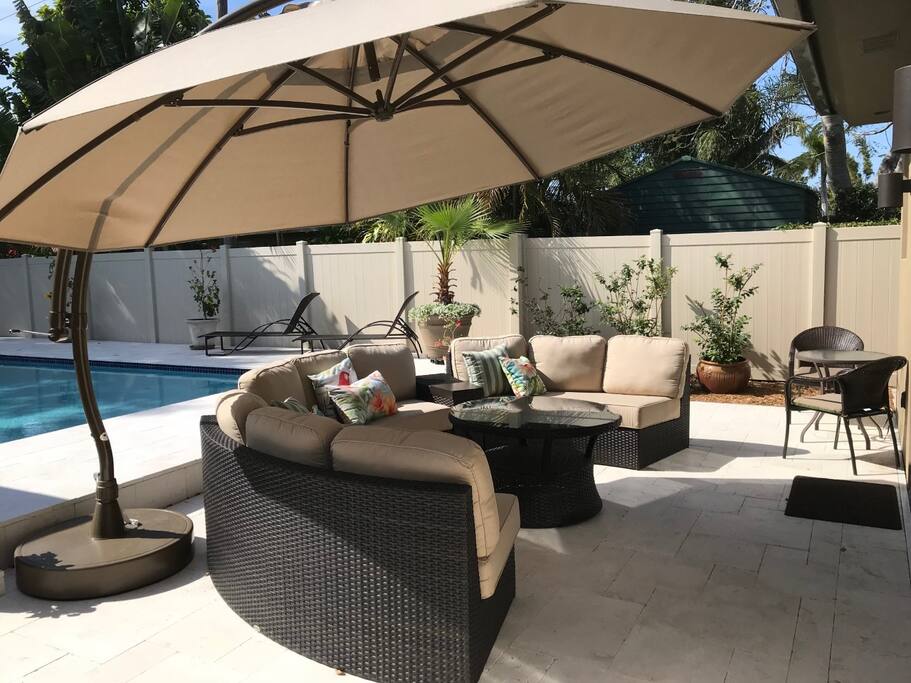 New patio furniture and an oversize arching patio umbrella.