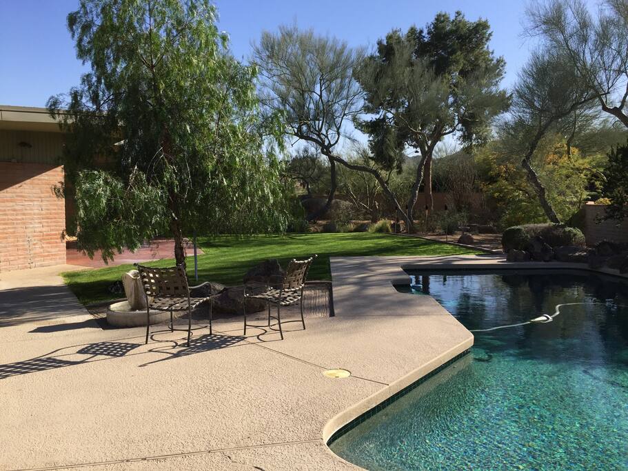 Lush landscaping in the backyard. Le jardin est luxueux aux arbres et gazon.