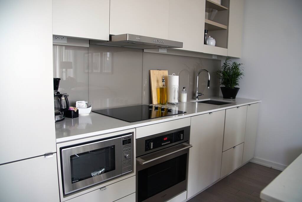 Fully equipped kitchen with microwave, dishwasher, toaster, blender, coffee maker and snacks.