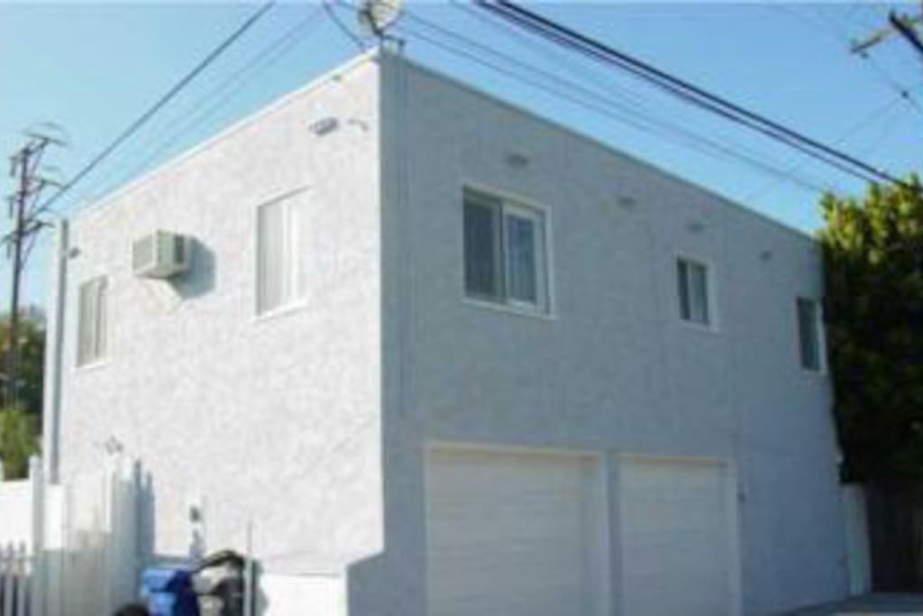 Back view showing garage and parking spaces