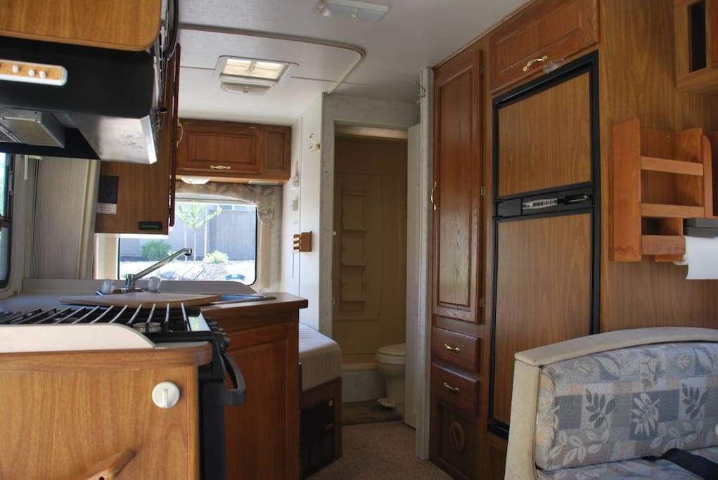Rear view of kitchen showing refrigerator and back bedroom