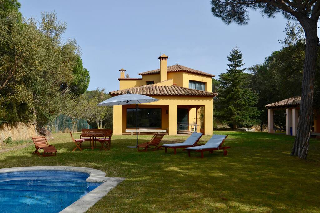 Contemporary house with traditional wooden beam features. Designed to be cool and provide shade in summer