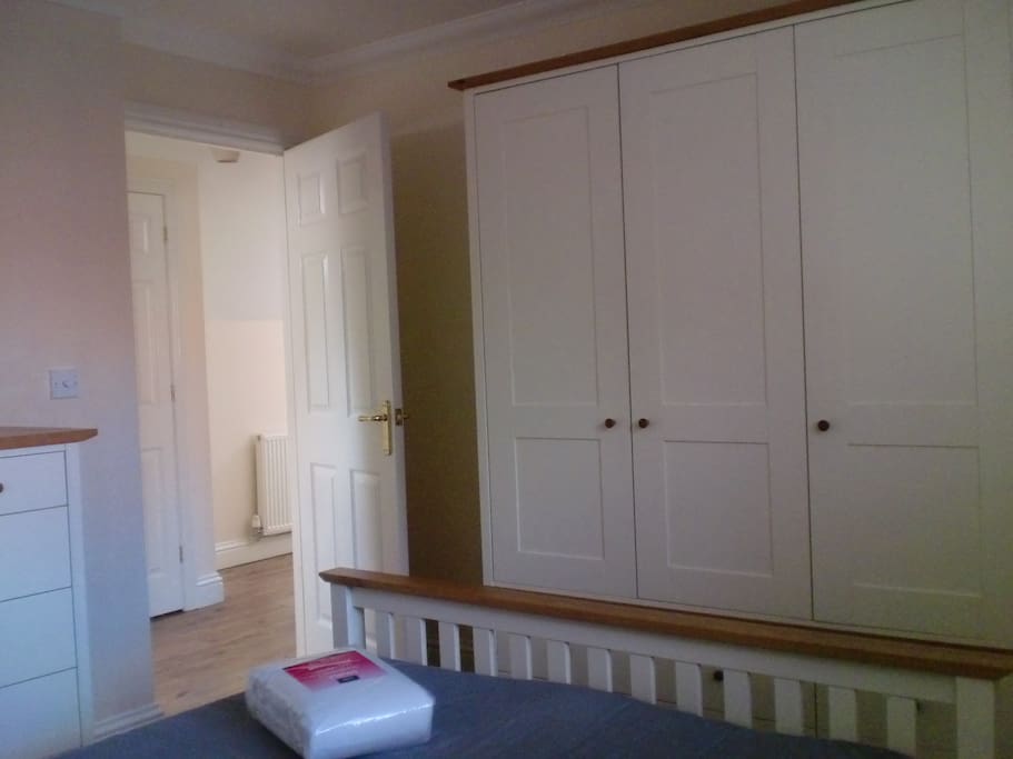 Double bedroom with a wardrobe which has drawers as well as hanging space and drawers
