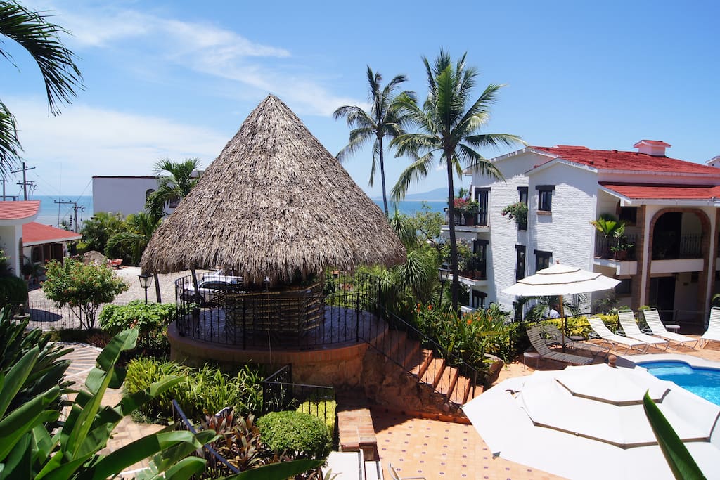 View from condo of pool area palapa and Pacific Ocean